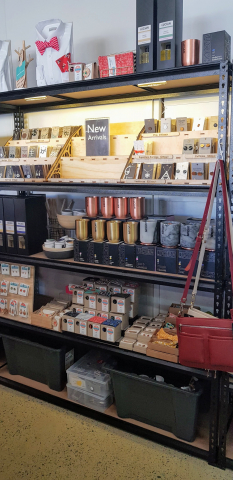 Shelf of hand made goodies at Tienda, including our CrankyBot items