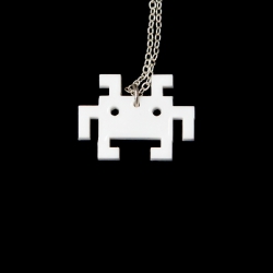 White laser cut space invader bot - a close up on a black background